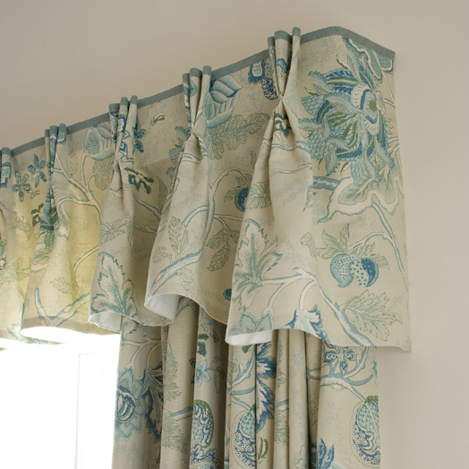 A shaped triple pleat valance with a contrast border on top edge